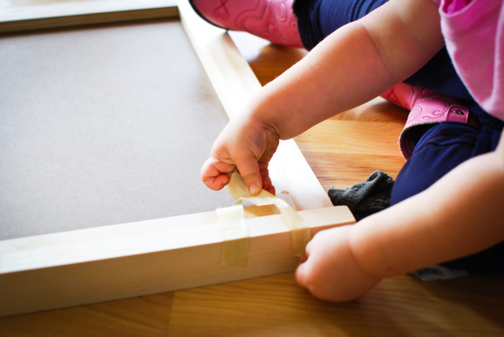 Toddler helping glue wood